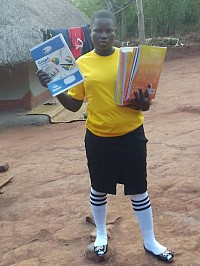A student receives scholastic materials to boost her education